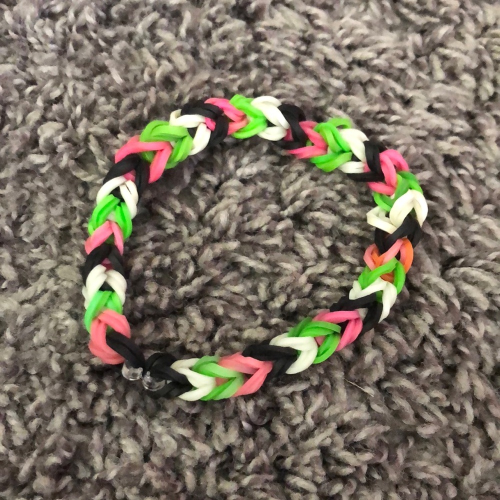 PINK BLACK WHITE AND GREEN RUBBER BAND BRACELET